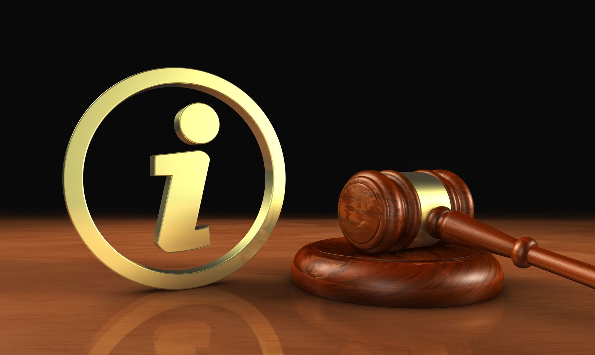 Golden information symbol next to a wooden gavel on a polished table.