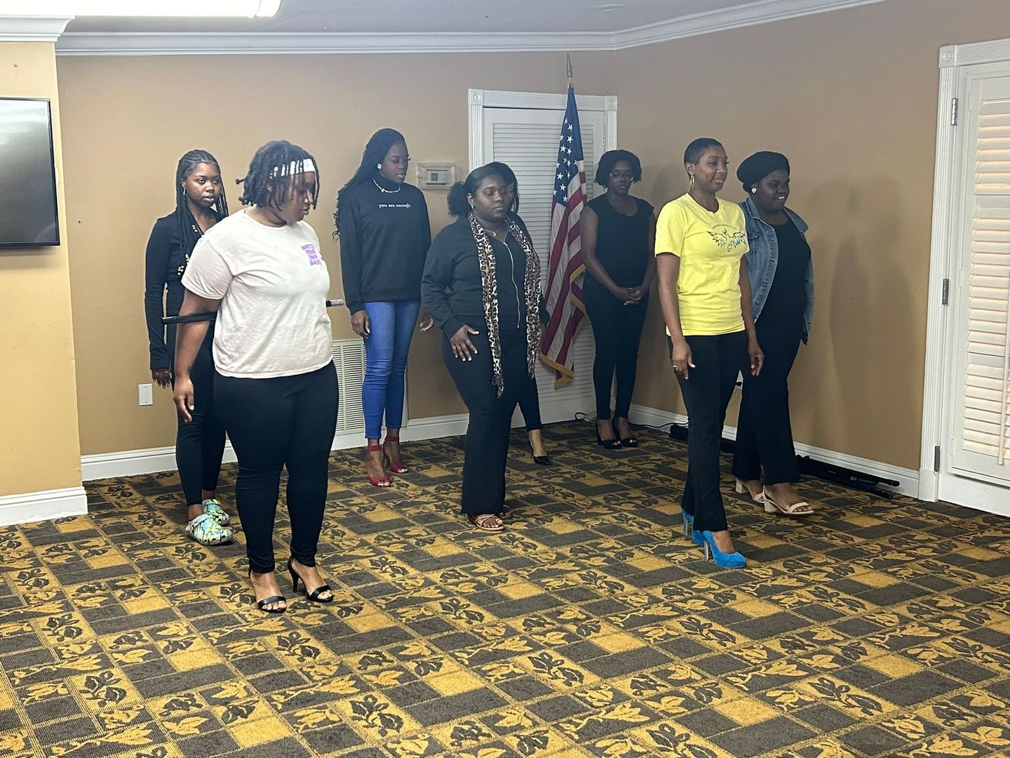 A group of women are standing in a room.