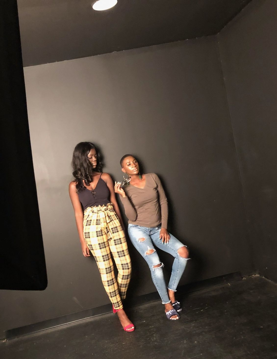 Two women standing next to each other in a dark room