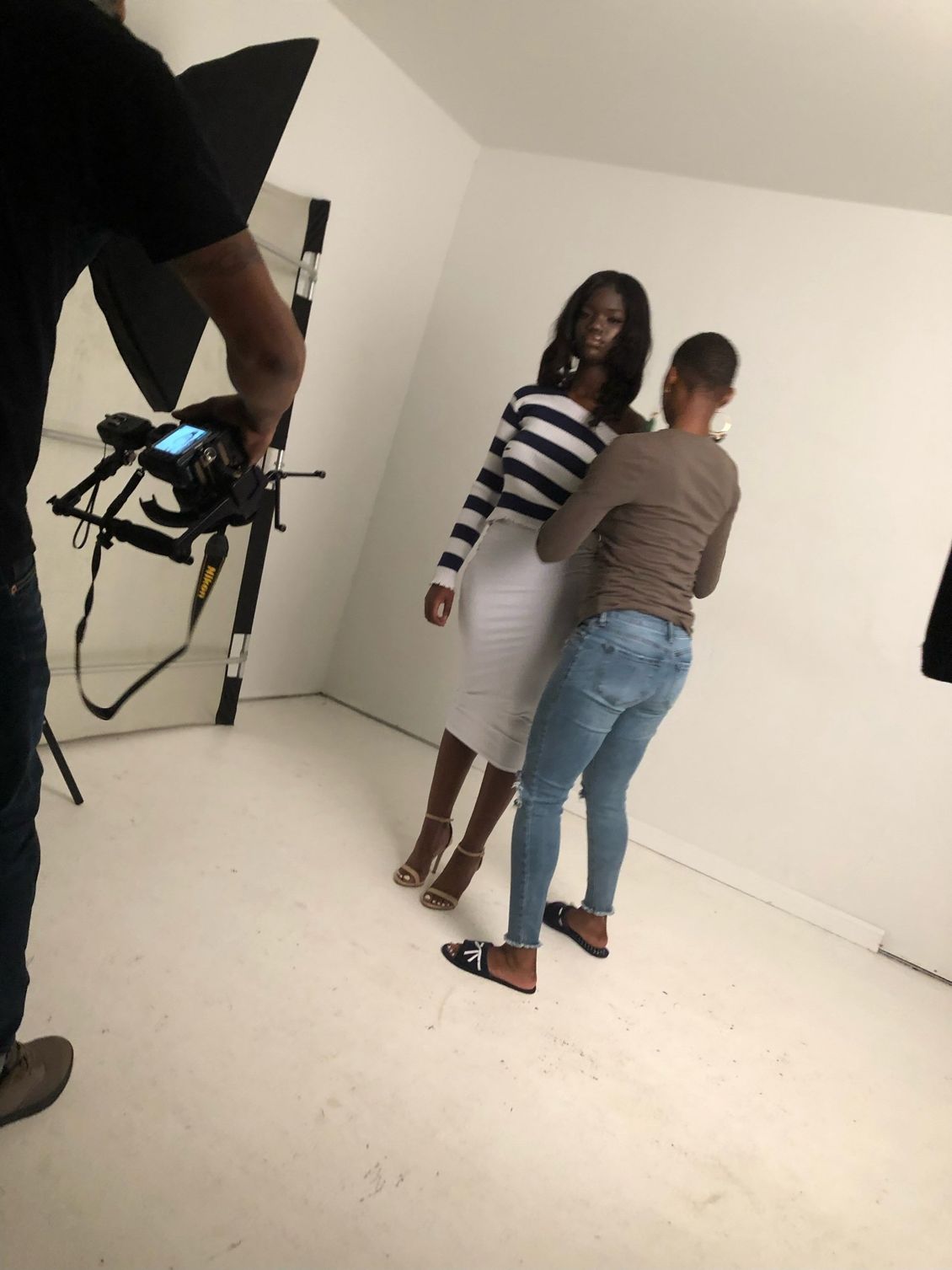 A woman in a striped shirt is standing next to another woman