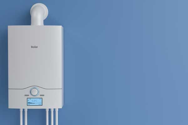 A white boiler is hanging on a blue wall.