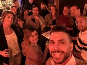 A group of people are posing for a picture in a bar.