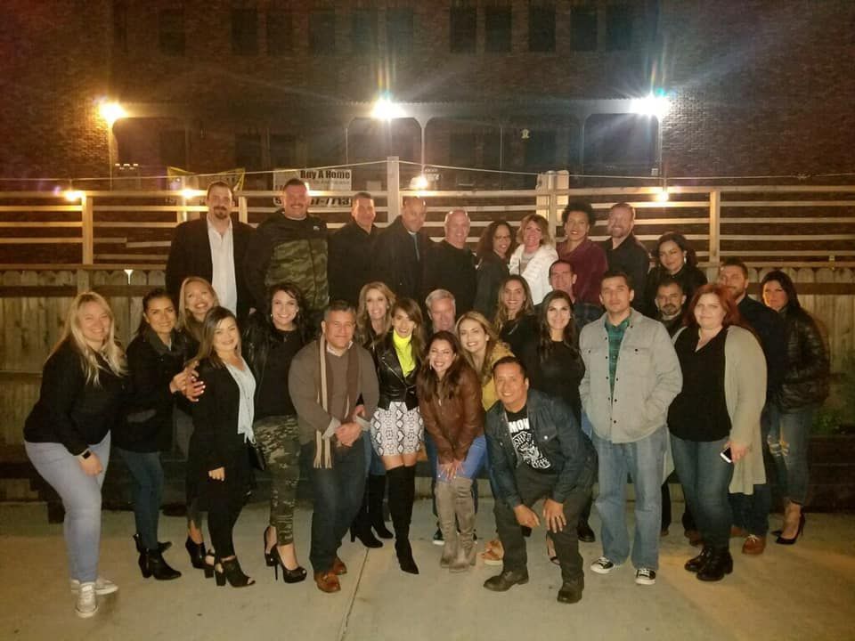 A large group of people posing for a picture at night