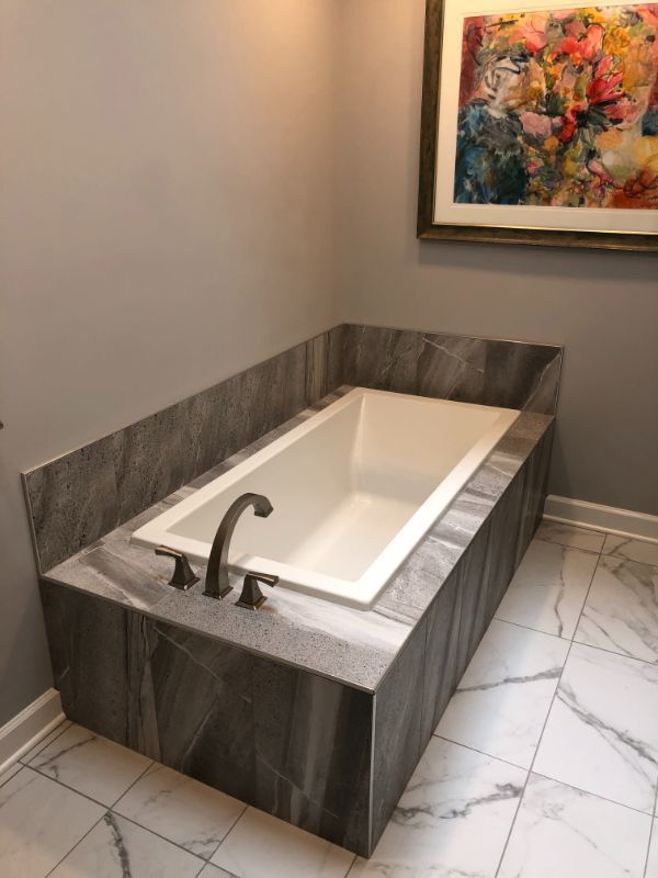A Bathtub in A Bathroom with A Picture on The Wall Above It | Tonao, VA | Don Kendrick