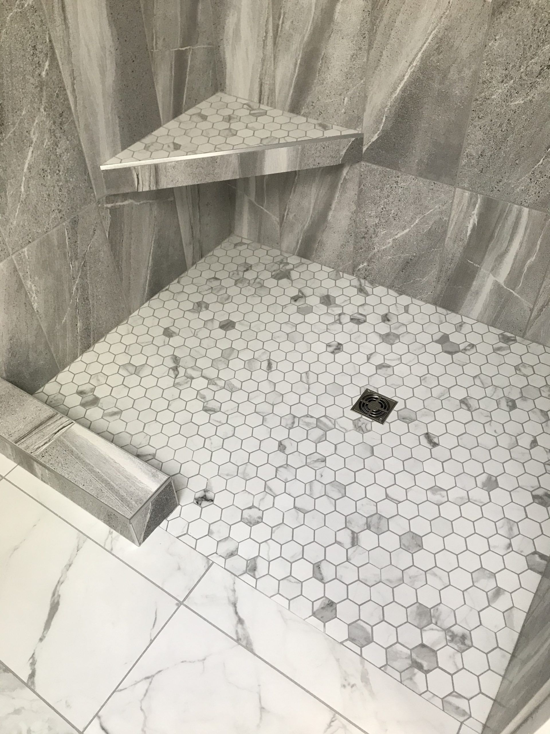 A Shower Stall with A Hexagonal Tile Floor and A Corner Shelf | Tonao, VA | Don Kendrick
