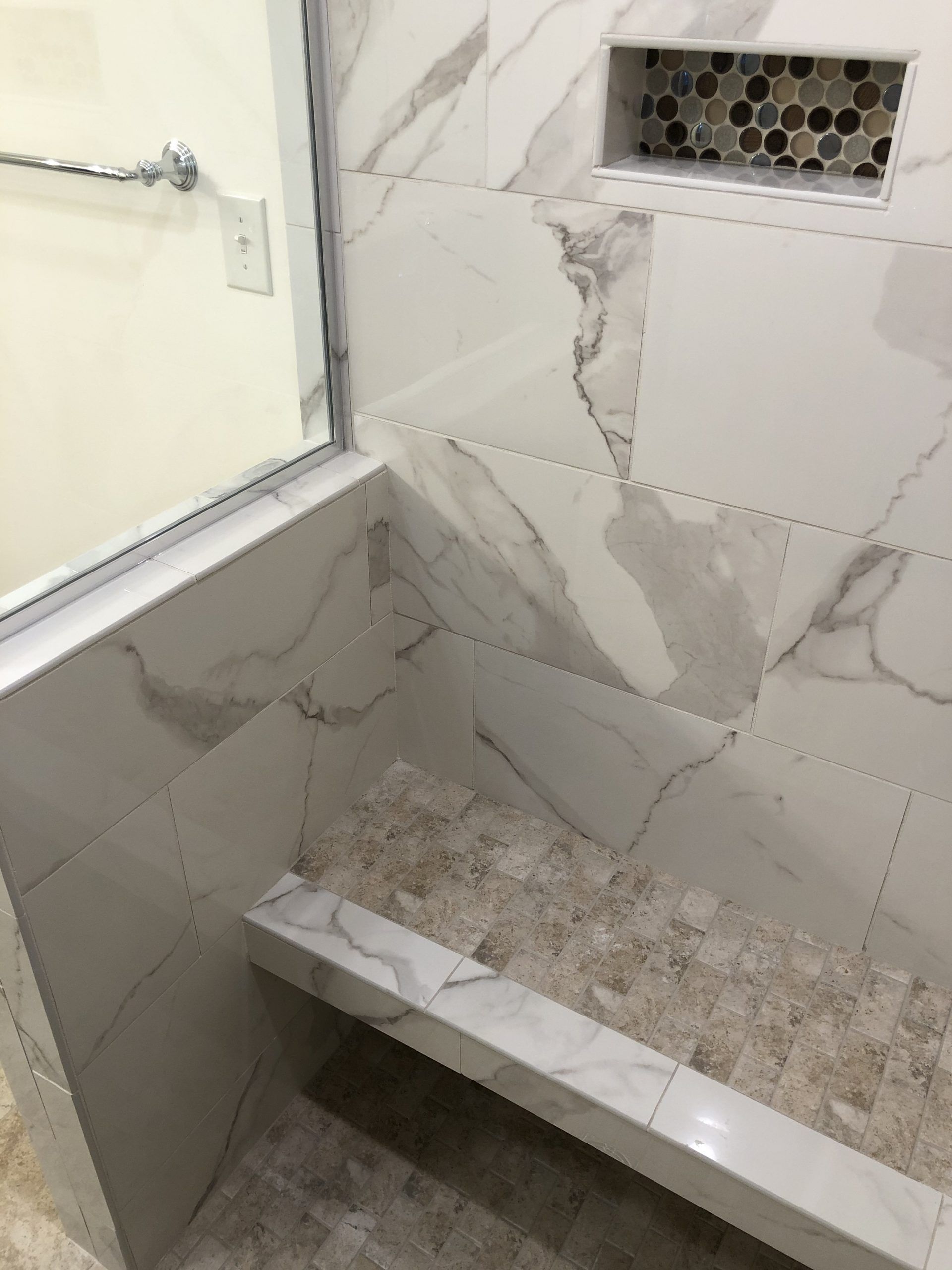 A Bathroom with Marble Tiles and A Bench in The Shower | Tonao, VA | Don Kendrick