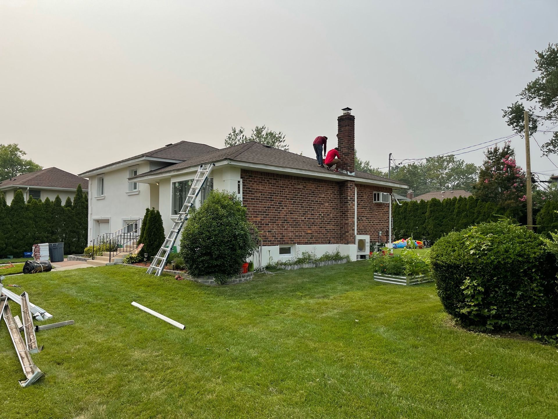 A man is working on the roof of a house.