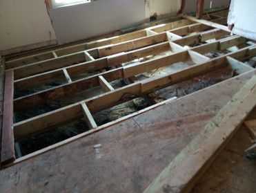 A wooden floor is being built in a room.