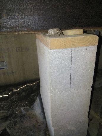 A concrete block with a wooden block on top of it.
