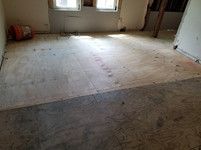 A room with a wooden floor and a window.