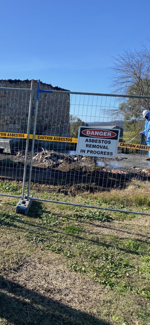 A fence with a danger sign on it is surrounding a construction site.