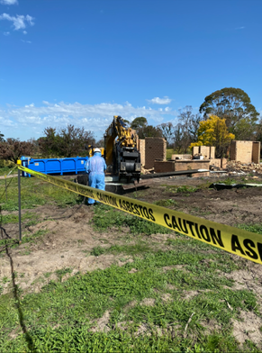 A fence with a yellow tape that says danger asbestos dust haz