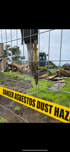 A pile of rusty pipes sitting on top of a black tarp.