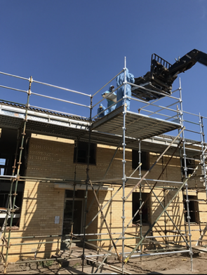 A construction site with scaffolding and a crane