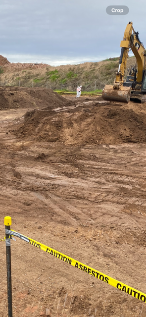 A bulldozer is moving dirt in a construction site.