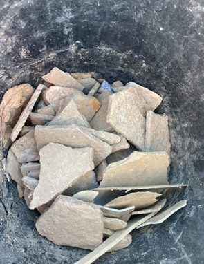 A pile of rocks with a wooden spoon in it