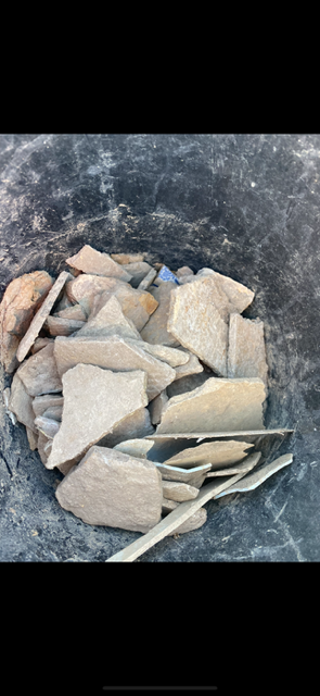A pile of rocks sitting on top of a black surface.