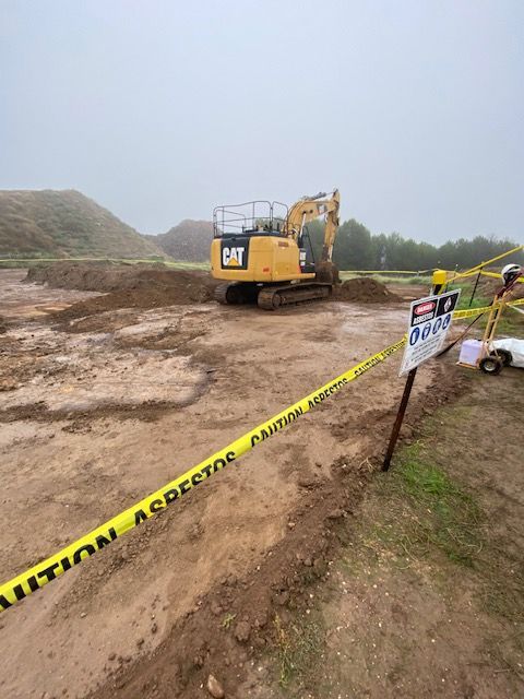 A construction site with a cat excavator in the background
