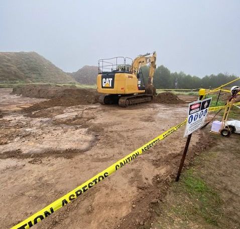 A construction site with a cat excavator in the background