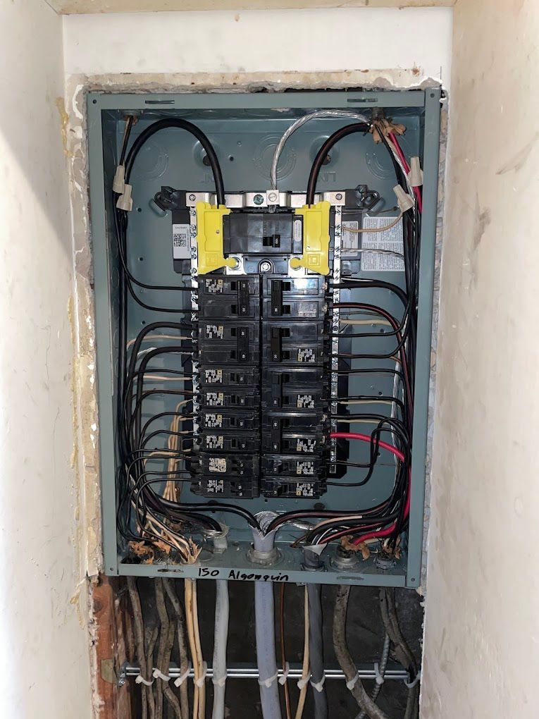 A electrical box with a lot of wires coming out of it.