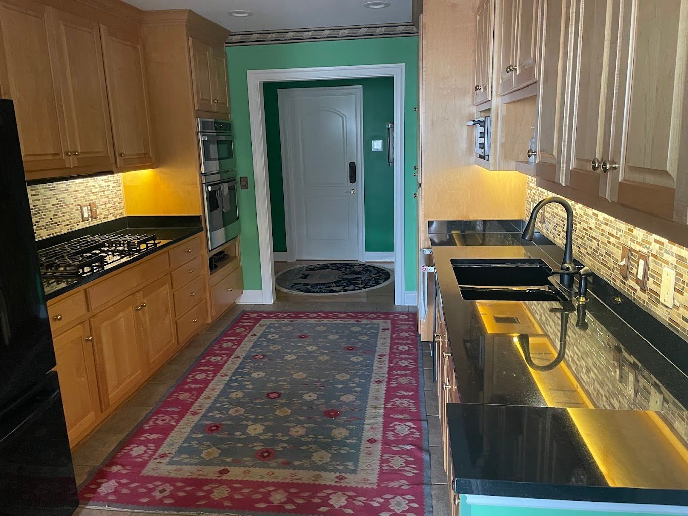 A kitchen with wooden cabinets and stainless steel appliances