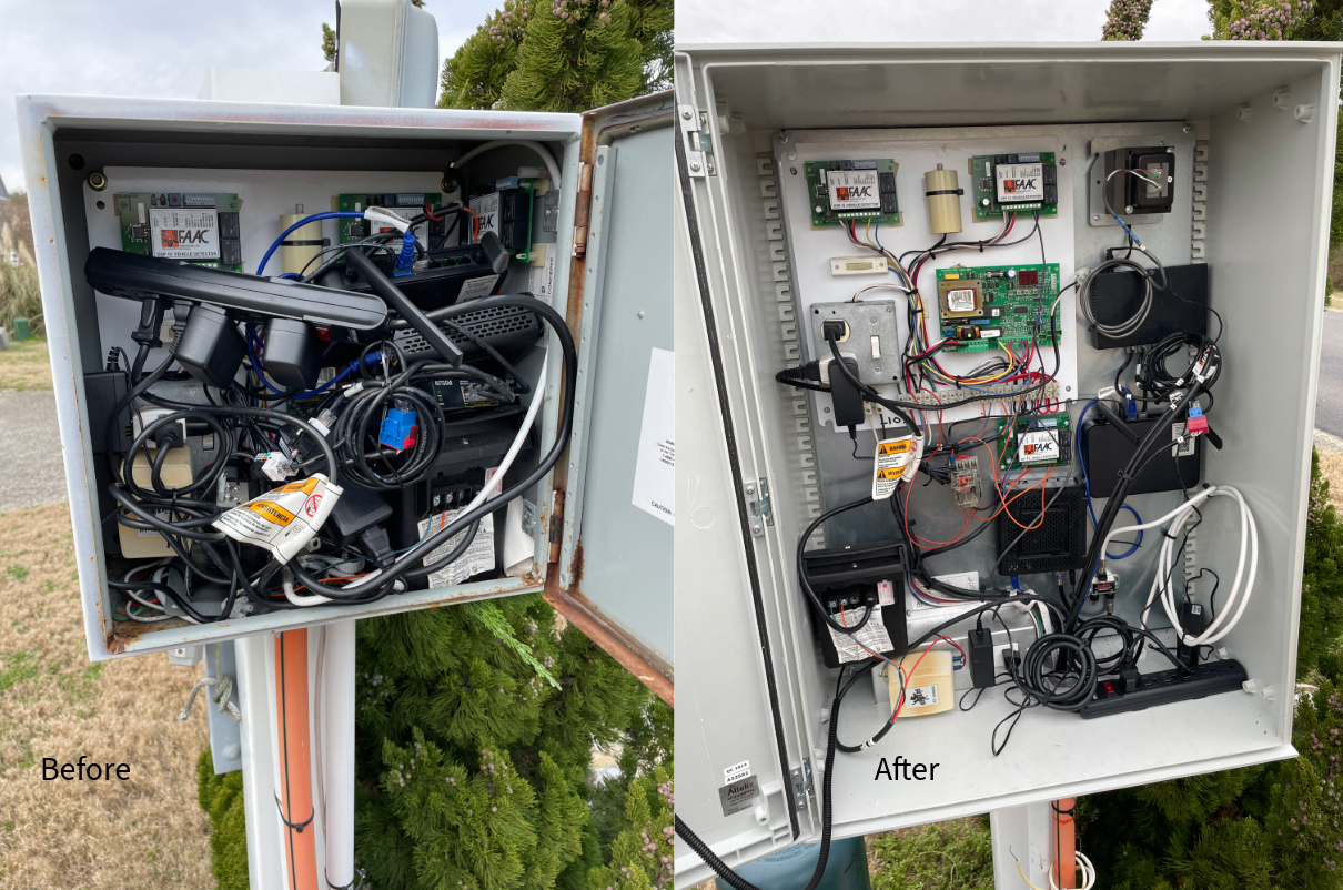 A box filled with lots of wires and electronics is sitting on a pole.