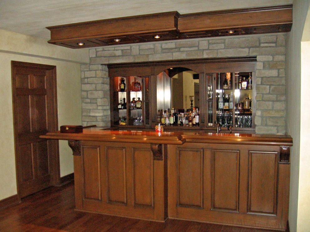 A wooden bar with a brick wall behind it.