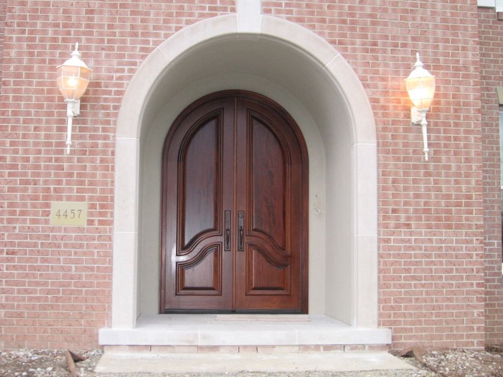 The front door of a brick house has the number 4437 on it.