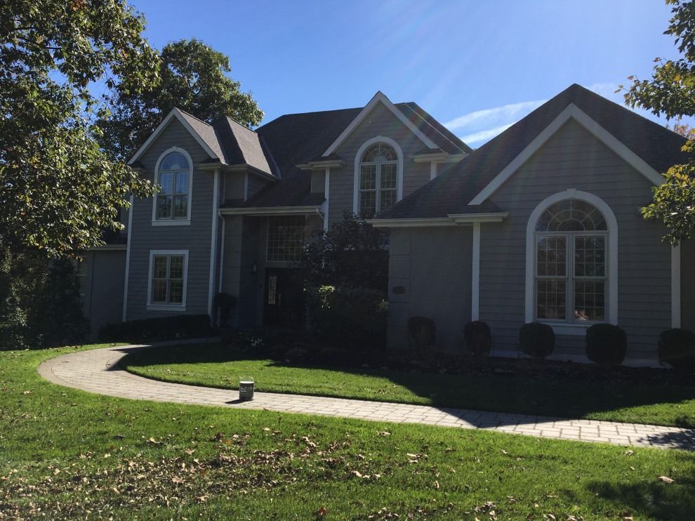 A large house with a walkway leading to it.