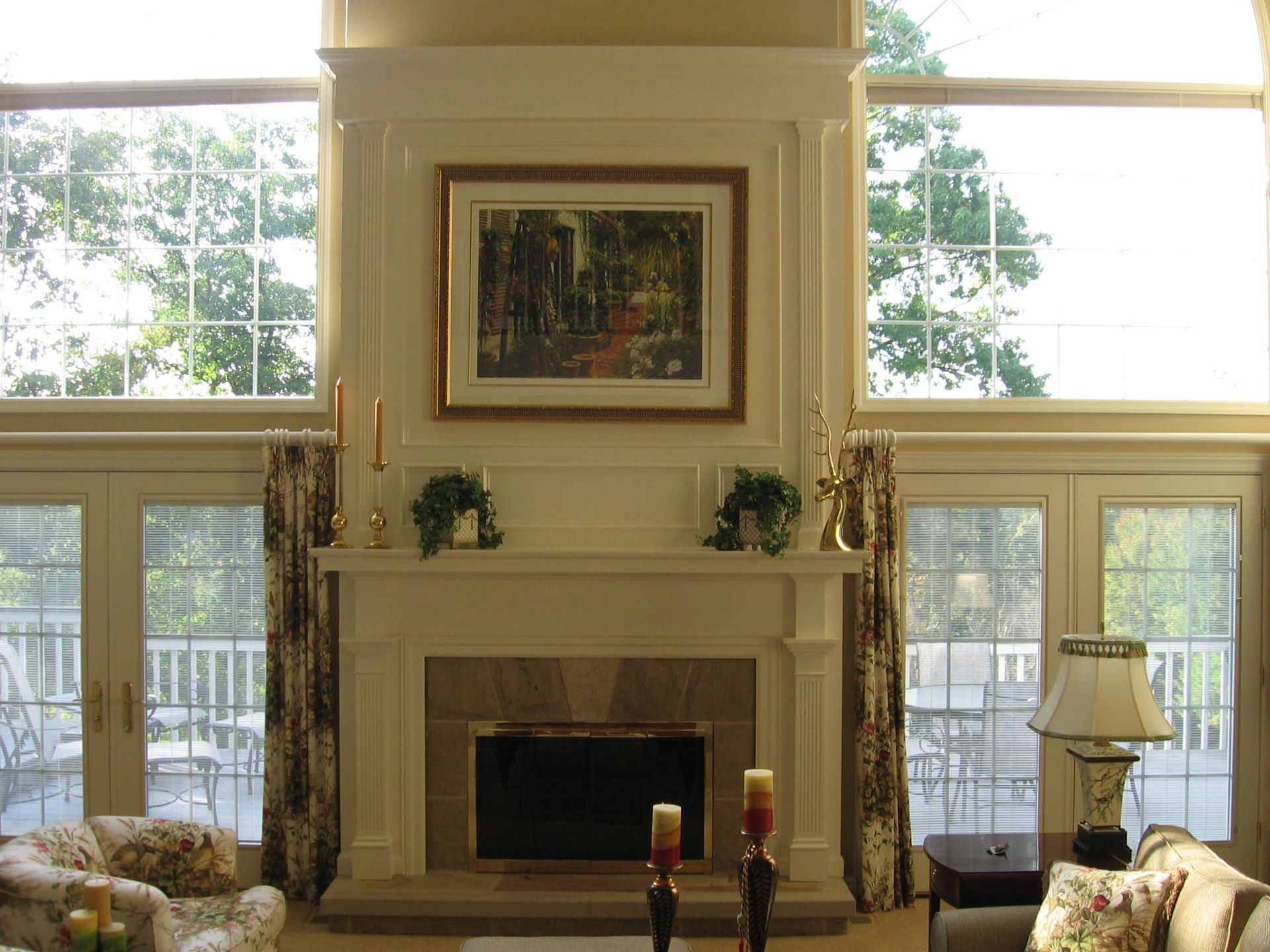A living room with a fireplace and lots of windows.
