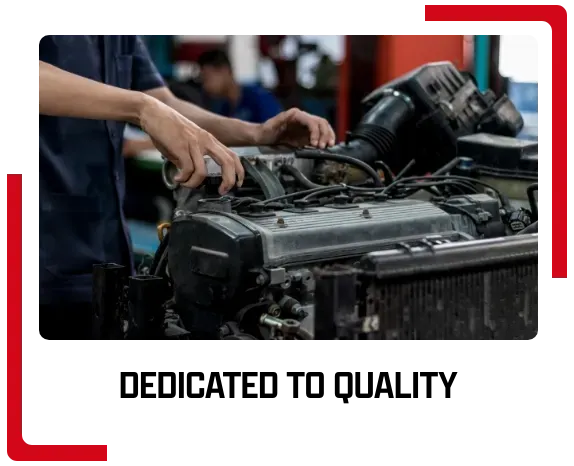 A man is working on a car engine in a garage.