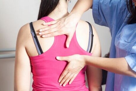 Woman having a back pain checkup — Jersey City, NJ — Pain and Disability Institute