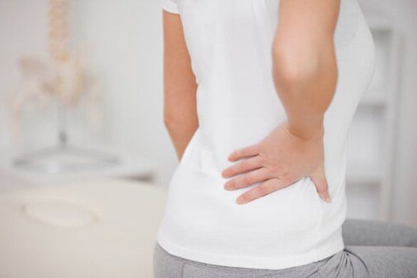 Middle age woman having lower back pain — Jersey City, NJ — Pain and Disability Institute
