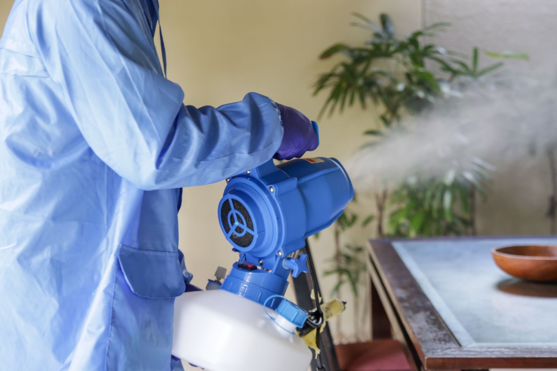 a man is spraying a room with a machine