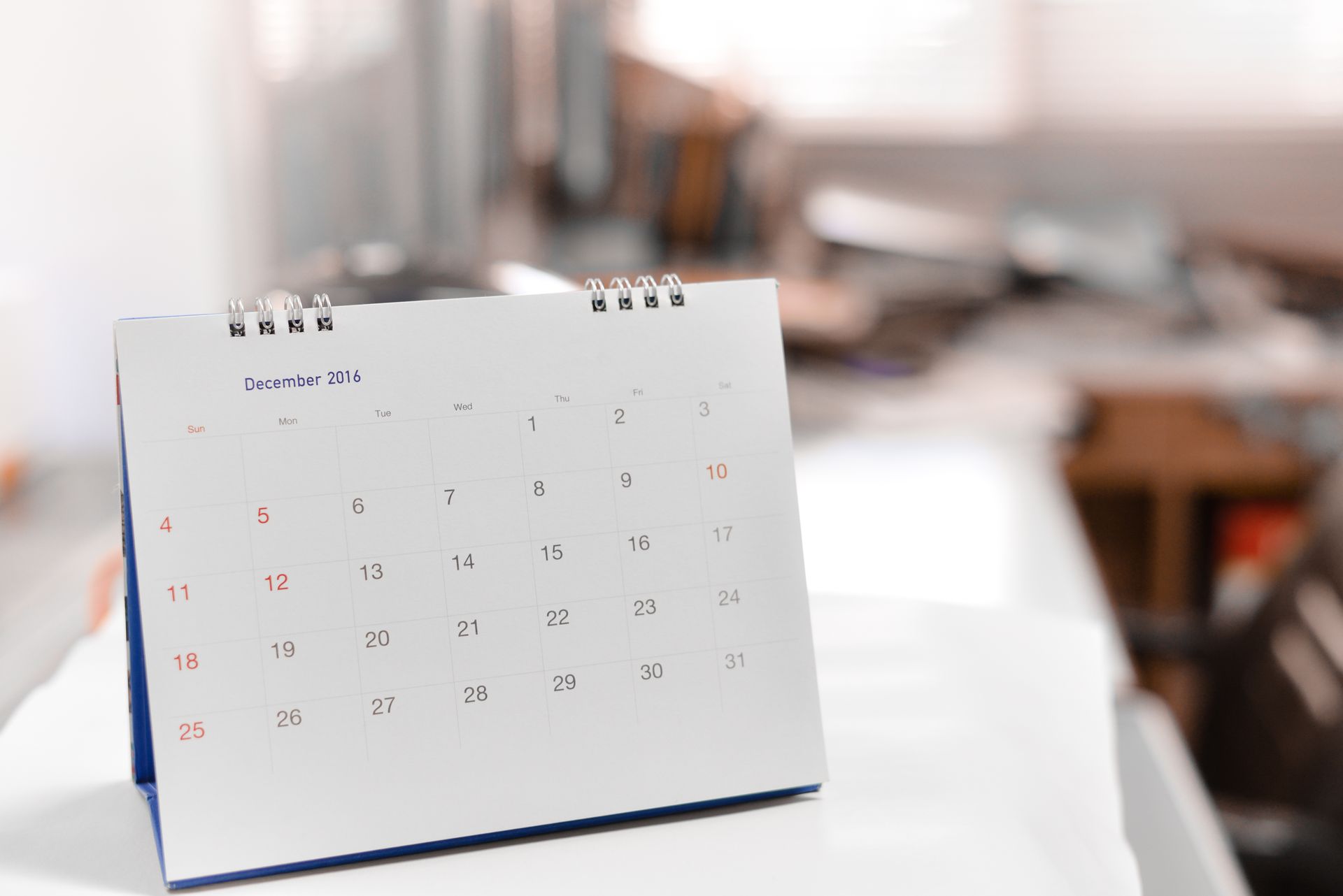 a calendar is sitting on top of a white table