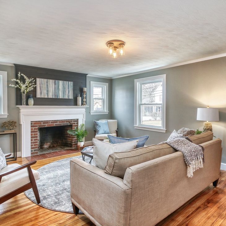 a living room with a couch a chair and a fireplace