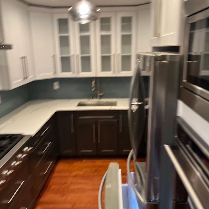 a kitchen with stainless steel appliances and white cabinets
