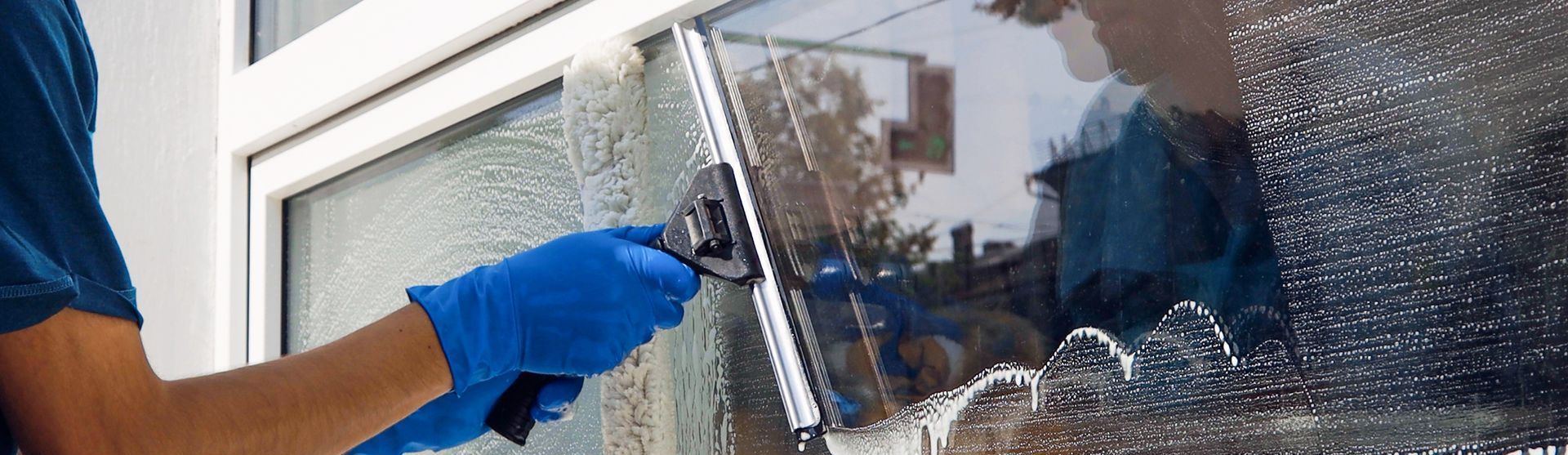 a man is cleaning a window with a squeegee