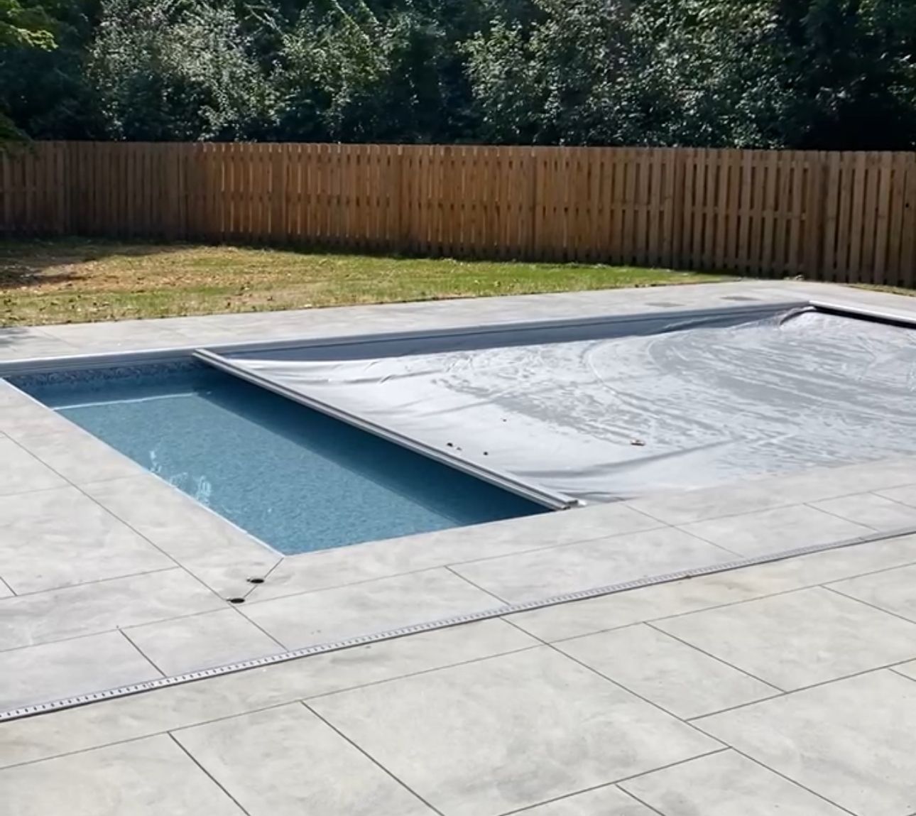 A large swimming pool with a shed in the background