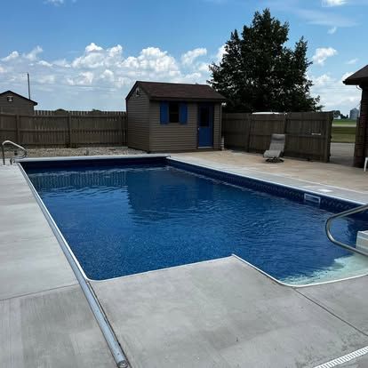 A man is working on an empty swimming pool.