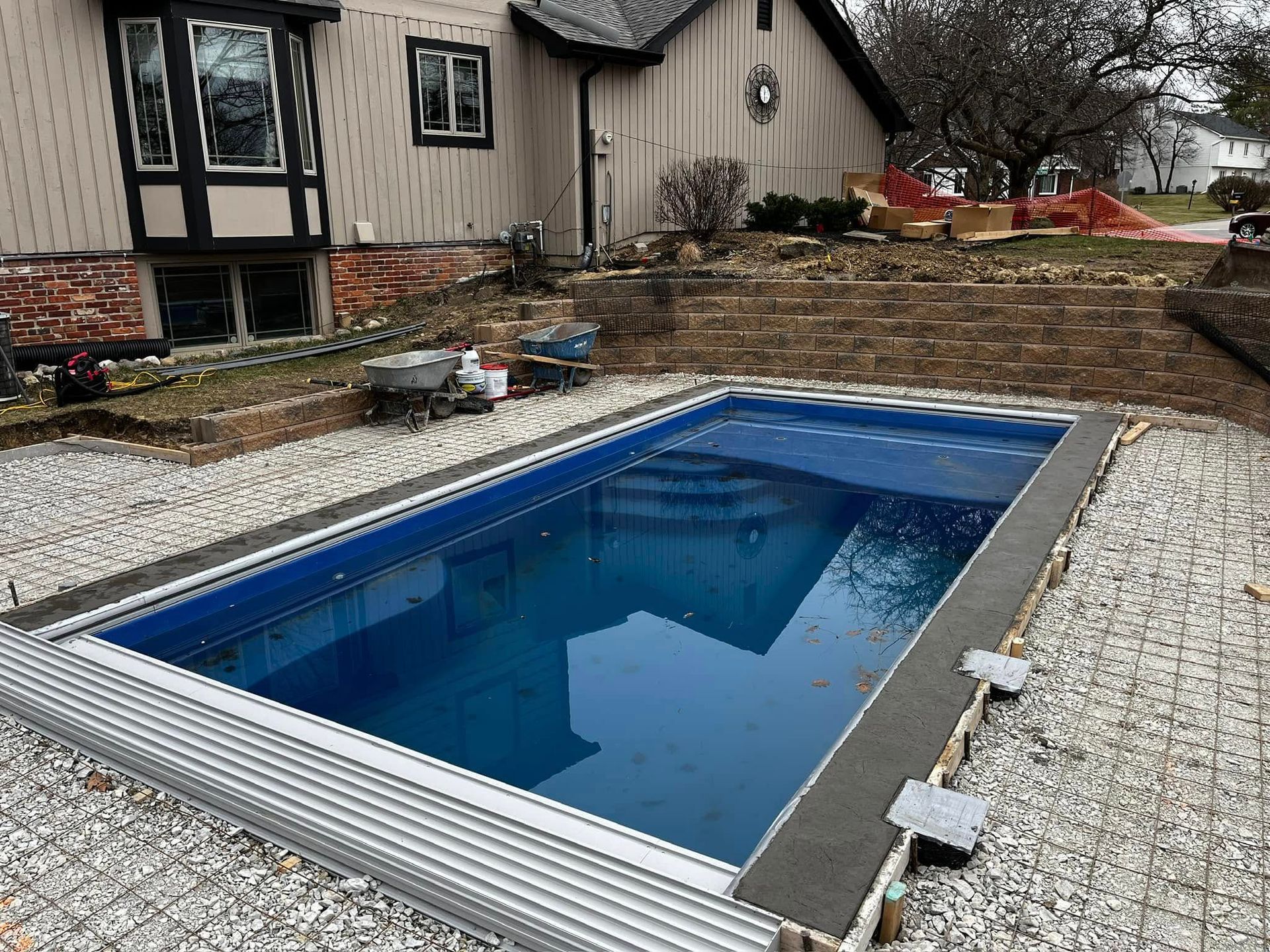A group of people are working on a swimming pool.