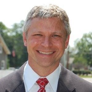 Preston Bowles . Smiling man in a suit and tie, light hair, outdoors, possibly in front of a building.