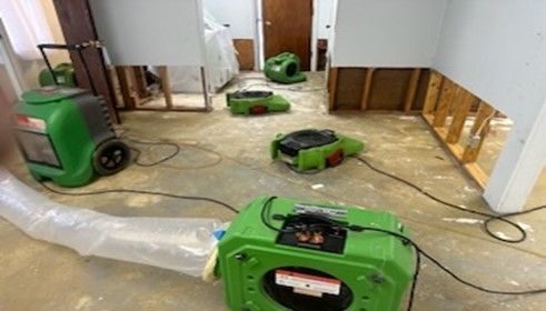 A room with a lot of green appliances on the floor.
