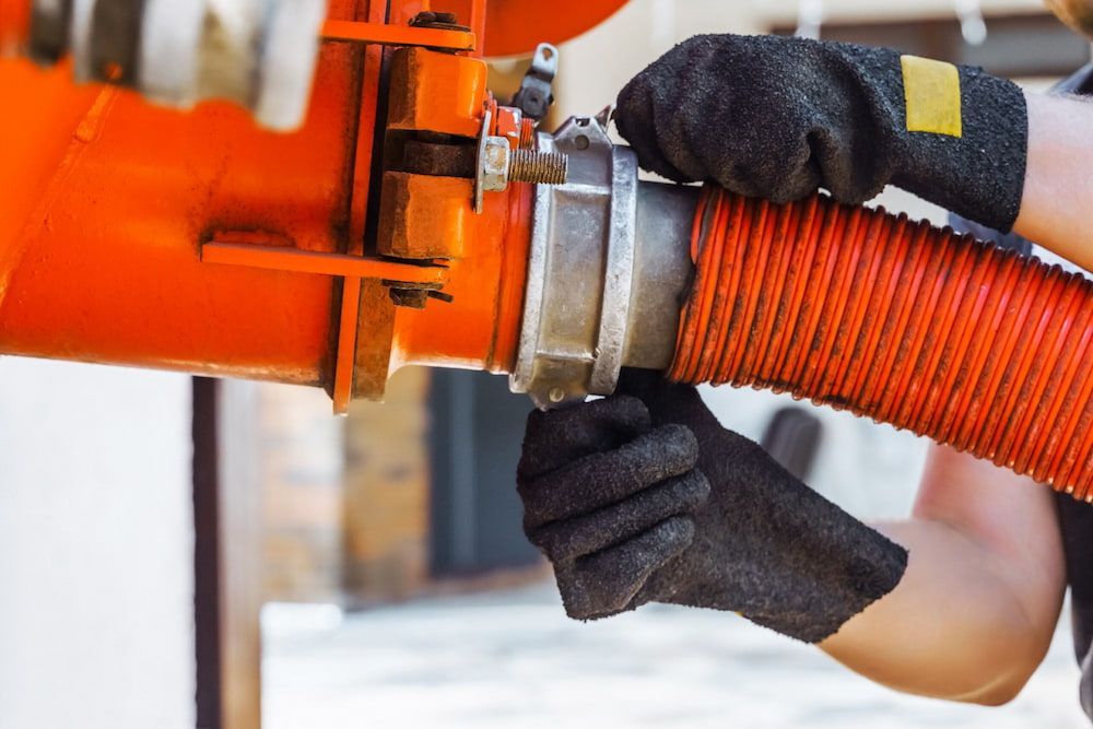 A Person is Holding a Red Hose in Their Hands — Paul Jennings in Mareeba, QLD