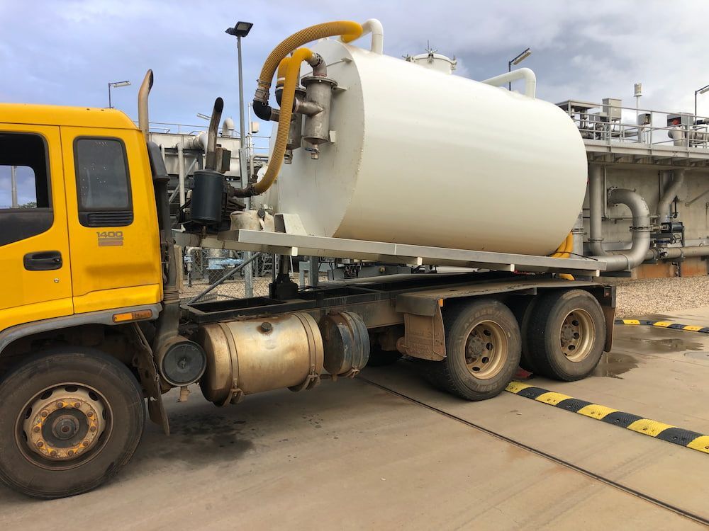 A Yellow and White Vacuum Truck is Parked on the Side of the Road — Paul Jennings in Mareeba, QLD