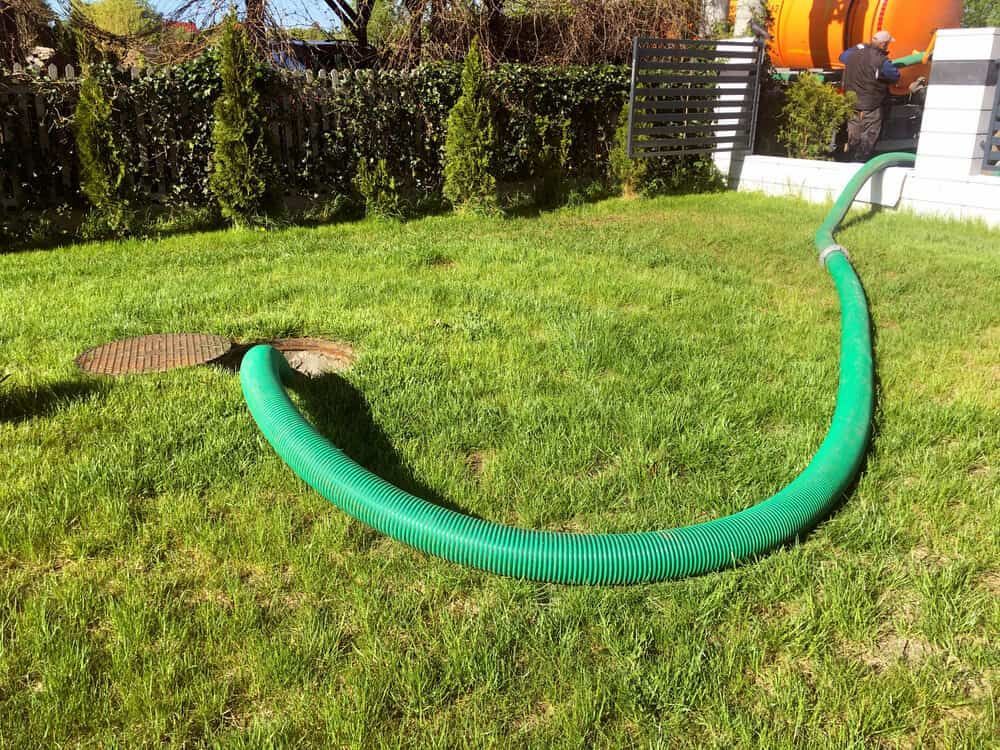 A Green Hose is Sitting on Top of a Lush Green Lawn — Paul Jennings in Dimbulah, QLD