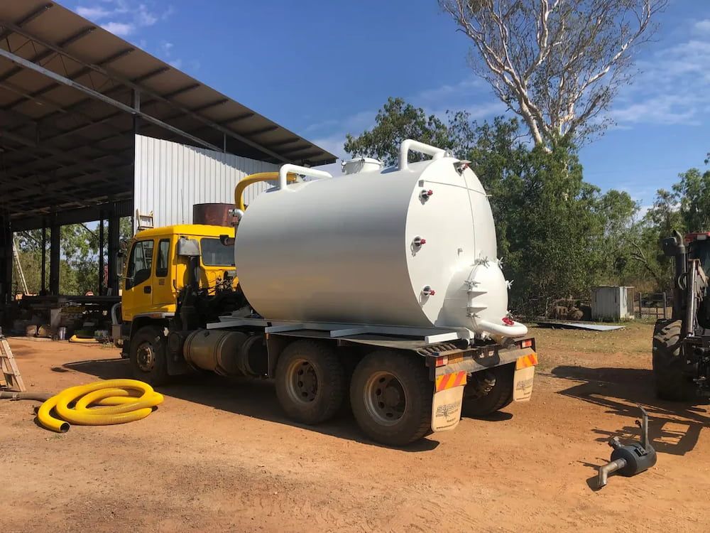 A Yellow and White Truck is Parked in Front of a Building — Paul Jennings in Mareeba, QLD