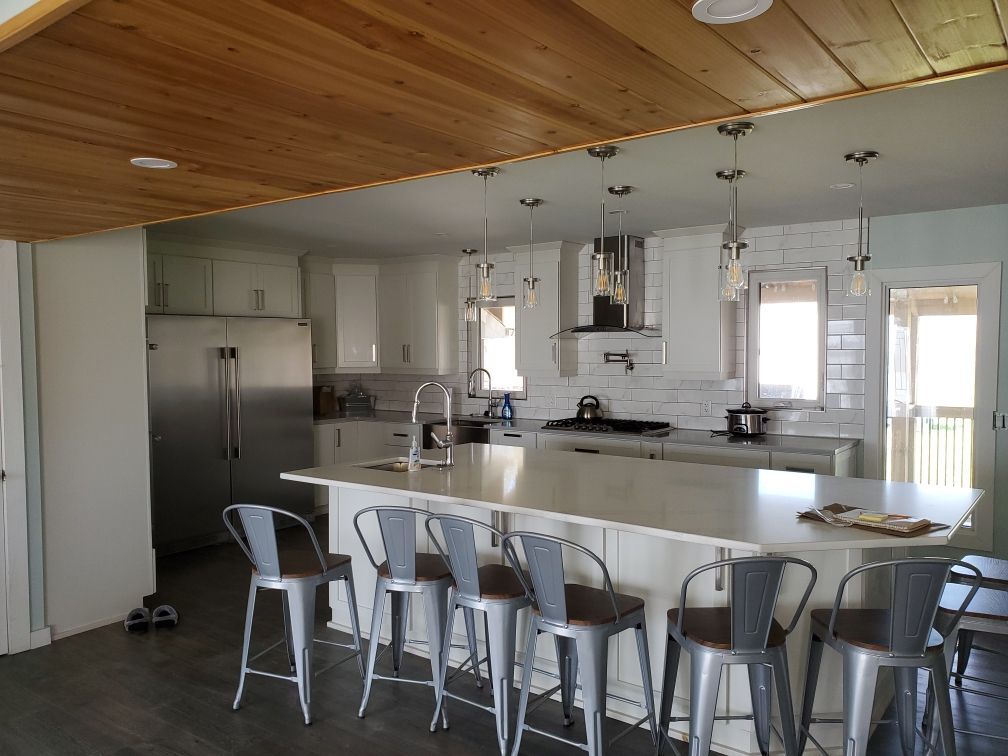 A kitchen with a large island and stools