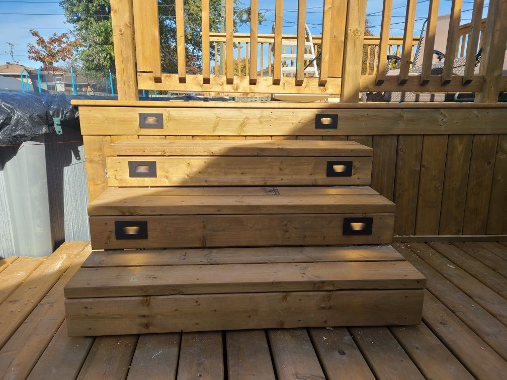 A wooden deck with stairs leading up to it