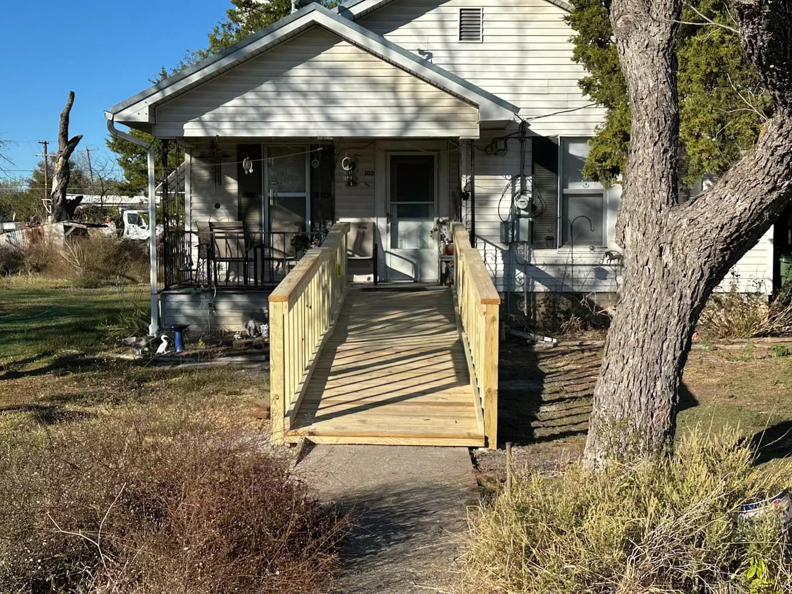A house with a wooden ramp leading to the front door.